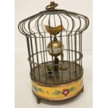 An ornamental wind up birdcage clock with yellow cloisonné panel to base.