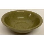 A Chinese crackle glazed celadon dish with hidden design to inner bowl.