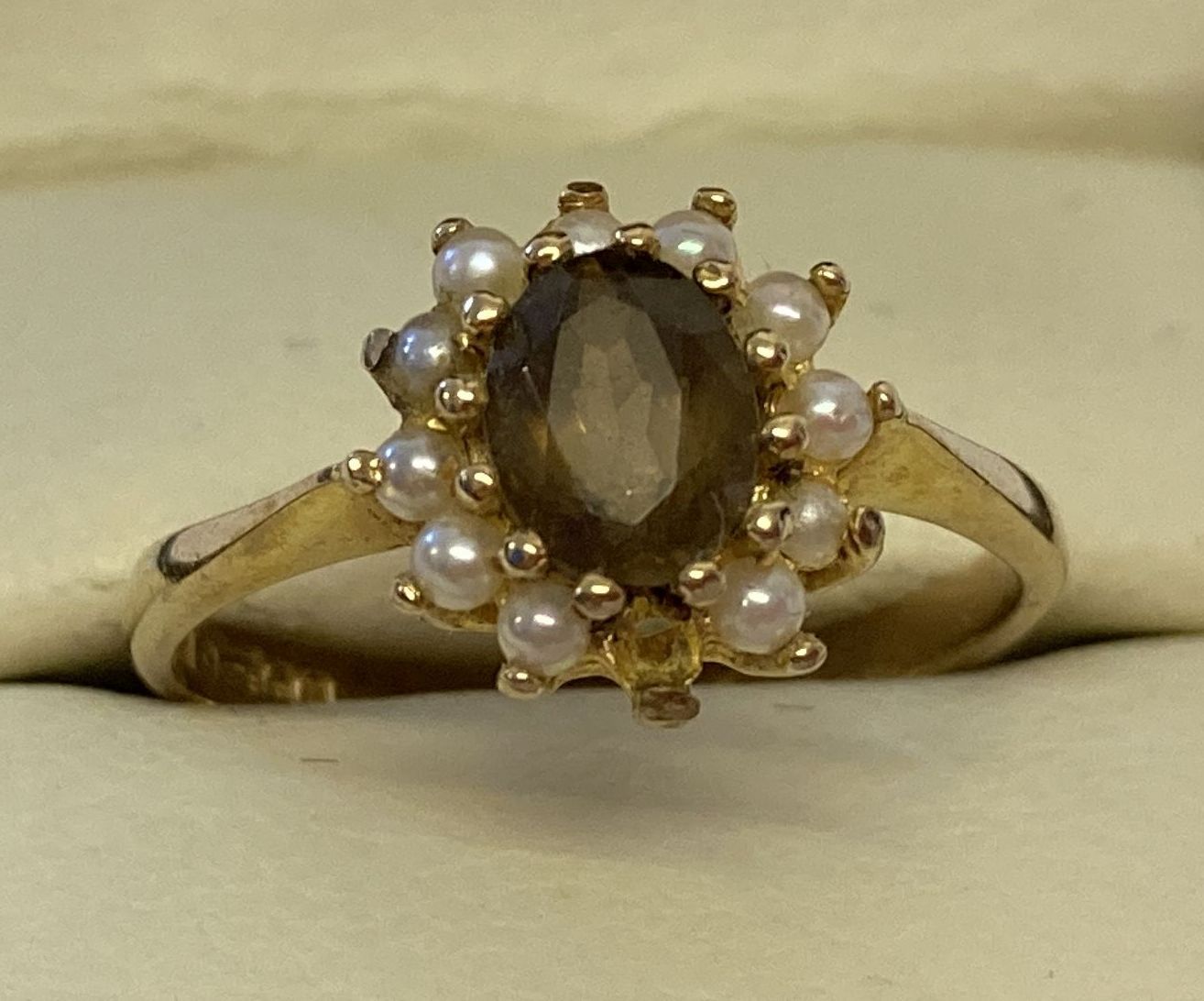 A 9ct gold dress ring set with smoked quartz and seed pearls.