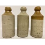 3 vintage stoneware ginger beer bottles with local manufacturer advertising.