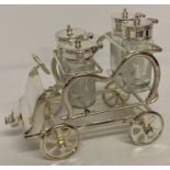 A novelty silver plated cruet stand in the shape of a vintage car.