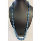 A long graduating turquoise bead necklace with vintage white metal clasp.