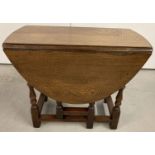 A small solid oak drop leaf gate leg coffee table.