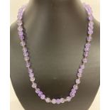 A 20" rock crystal and glass beaded necklace with white metal T bar clasp.