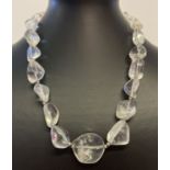A rock crystal irregular shaped graduating bead necklace with white metal spring clasp.