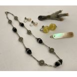 A collection of assorted vintage jewellery items to include a mother of pearl hair clip.