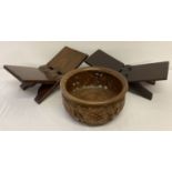 A large Balinese carved wood fruit bowl together with 2 folding wooden book rests, also Balinese.