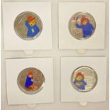 A set of 4 Paddington Bear 50p coins with coloured decals.