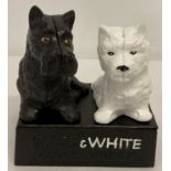 A painted cast iron advertsing stand depicting two Scottie dogs for "Black & White Whiskey".