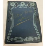 A blue Art Nouveau postcard album containing a quantity of assorted postcards and greetings cards.