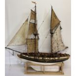 A scratch built pirate ship pond yacht with sails, rigging, figure, stand and internal workings.