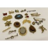 A collection of vintage jewellery brooches, pendants, cufflinks and tie pins.