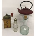 A cast metal Chinese tea kettle In maroon finish with circular bobble decoration.