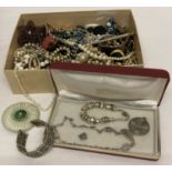 A box of vintage and modern costume jewellery necklaces, brooches and bracelets.