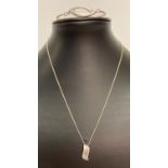 A modern wave design pendant in plain and brushed silver on an 18" fine curb chain.