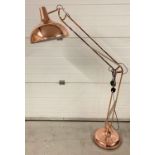 A large copper standard lamp in the style of an angle poise lamp.