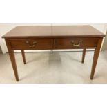 A dark wood 2 drawer low occasional table on taped legs and with brass drop down handles.