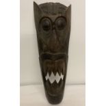 A dark wood carved African mask.