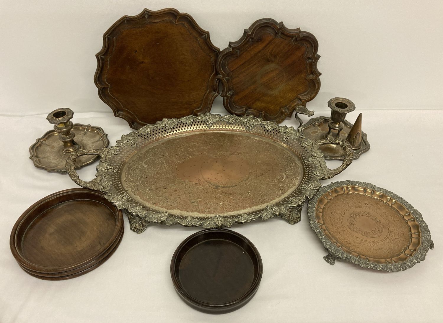 A small collection of silver plate to include a handheld candle stick and serving tray.