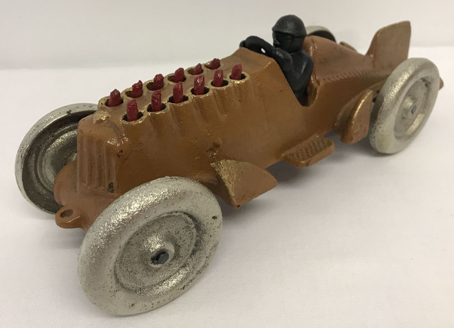 A painted cast metal model car with moving pistons.