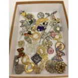A collection of vintage and modern, brooches, scarf clips and hat pins.