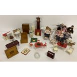A quantity of assorted dolls house furniture and dolls.
