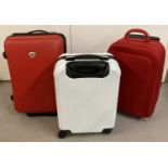 3 small wheeled cabin style suitcases.