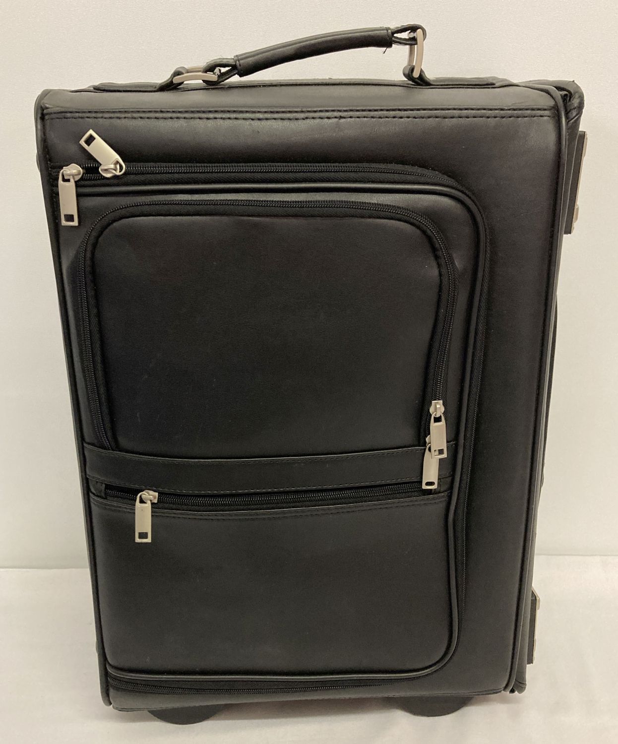 A wheeled faux leather pilot's case with combination locks.