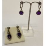 2 pairs of silver and amethyst set drop style earrings.