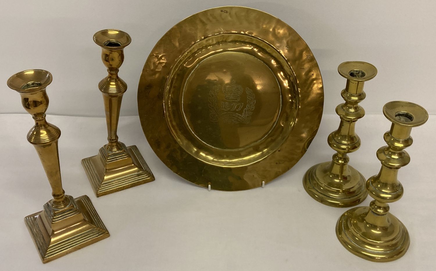 A collection of vintage brass ware items; 2 pairs of candlesticks together with a coronation plaque.