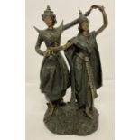 A resin figurine of a pair of Thai dancers.