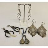 5 pairs of silver and white metal drop style earrings.