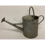 A large vintage 3 gallon galvanised watering can with screw-on rose.