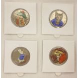 A set of 4 Beatrix Potter 2017 50p coins with coloured decals.