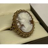 A 9ct yellow gold cameo dress ring. An oval cameo set in gold mount with rope design to outer edge.