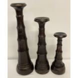 A set of 3 Balinese large wooden candle sticks.