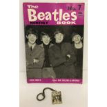 A vintage Beatles picture key ring together with a No.7 The Beatles Monthly Book.