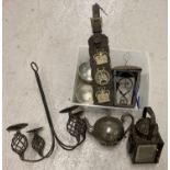 A box of mixed metal ware items. To include horse brasses, silver plate teapot and a lamp.