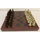 A Chinese chess set in folding wooden case with gilt dragon & pheasant decorative detail.