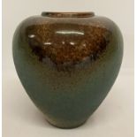 A studio pottery bulbous vase in green and bronze marked in relief ALS to bottom.