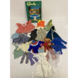 A collection of vintage dolls clothes to include handmade. Suitable for smaller dolls and Sindy.