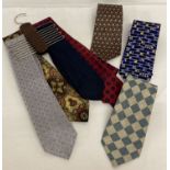 A collection of 7 silk and polyester neck ties together with a metal and wooden tie rack.