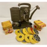 A vintage Noris 8 Junior film projector together with a collection of film reels.