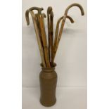 A collection of 10 vintage wooden walking sticks to include brass handled.