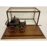 A scratch built model of a wooden Victorian horse drawn dog cart, with brass fittings.