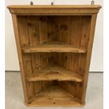 A pine 3 shelf corner wall hanging unit with shaped shelf fronts.
