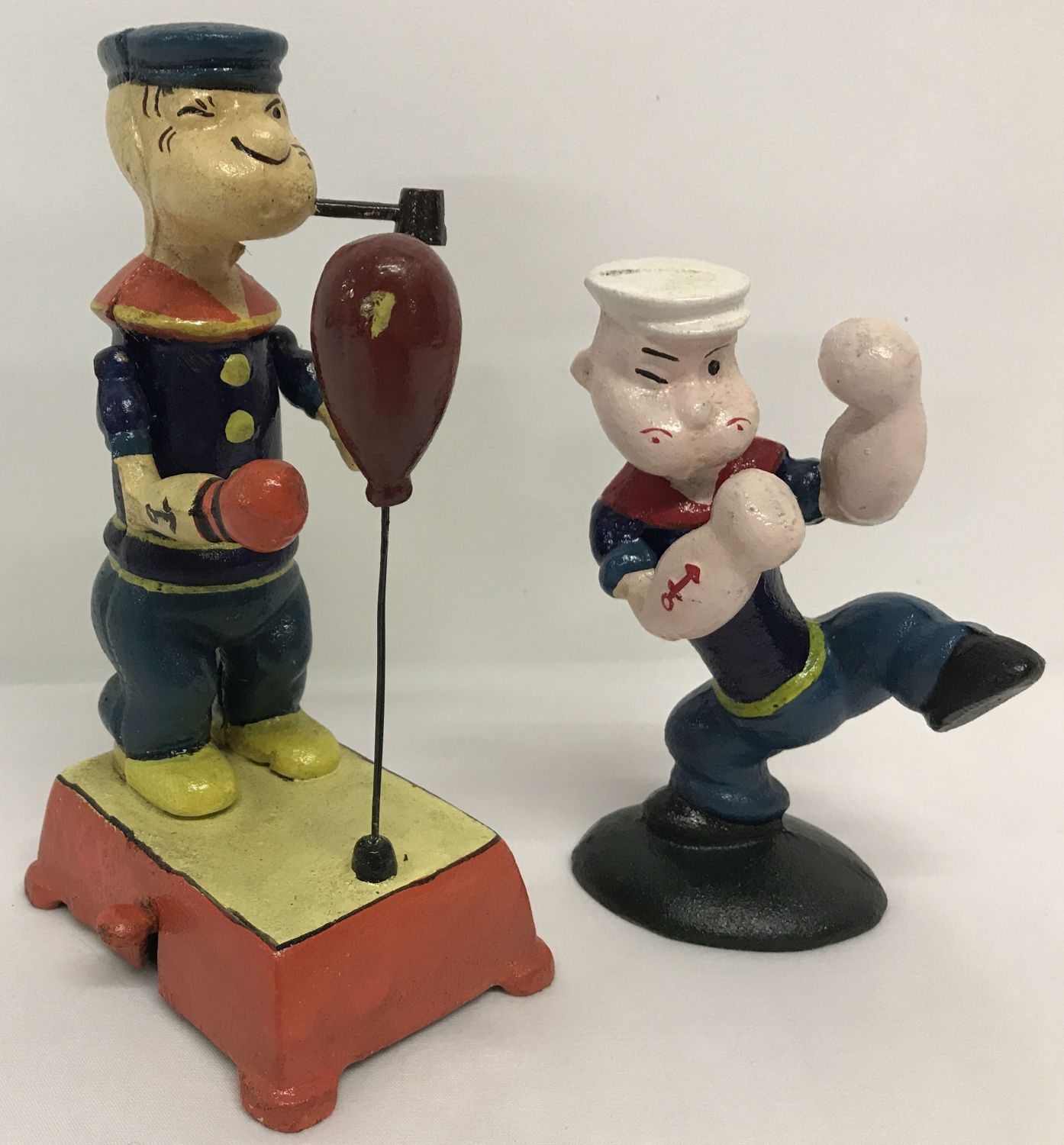 2 painted cast metal figures of Popeye, boxing.