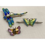A vintage silver bar brooch set with green, yellow and blue enamelled butterfly.