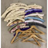 A collection of modern and vintage wooden and padded coat hangers. To include floral designs.