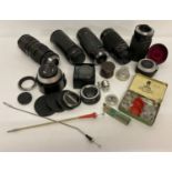 A collection of assorted photographic lenses and accessories.